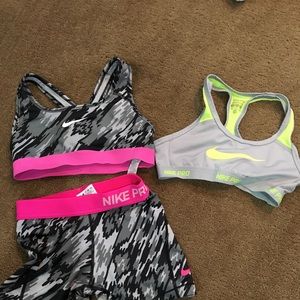 2 Nike sports bras and a pair of spandex
